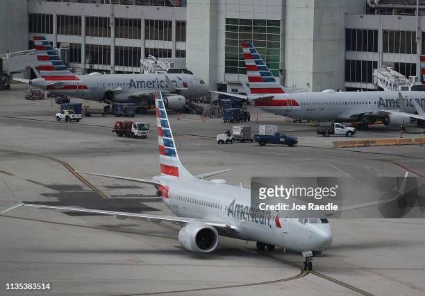 An American Airlines Boeing 737 Max 8 arriving from Washington's Ronald Reagan National Airport is seen taxiing to its gate at the Miami...
