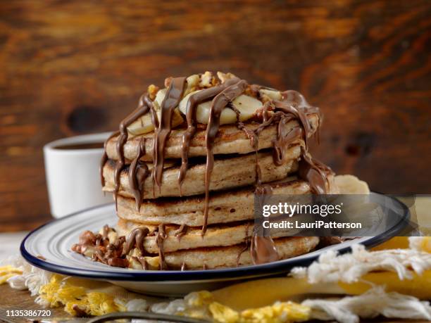 banana pancakes with chocolate sauce - hazelnut spread stock pictures, royalty-free photos & images