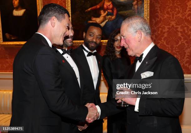Luke Evans speaks with Prince Charles, Prince of Wales during a dinner to celebrate 'The Princes Trust' at Buckingham Palace on March 12, 2019 in...