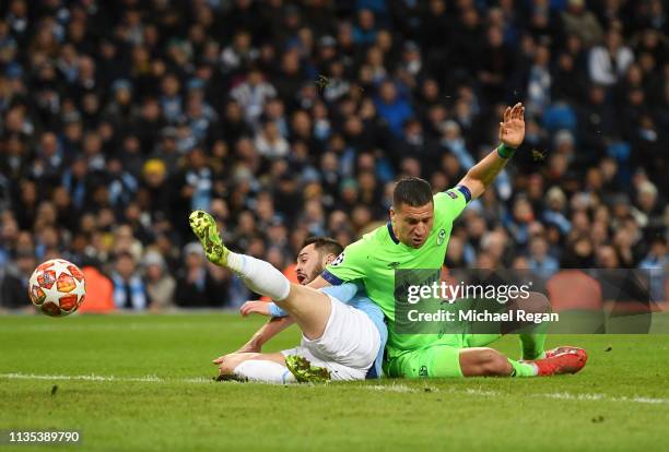 Jeffrey Bruma of Schalke 04 fouls Bernardo Silva of Manchester City which leads to a penalty being awarded during the UEFA Champions League Round of...