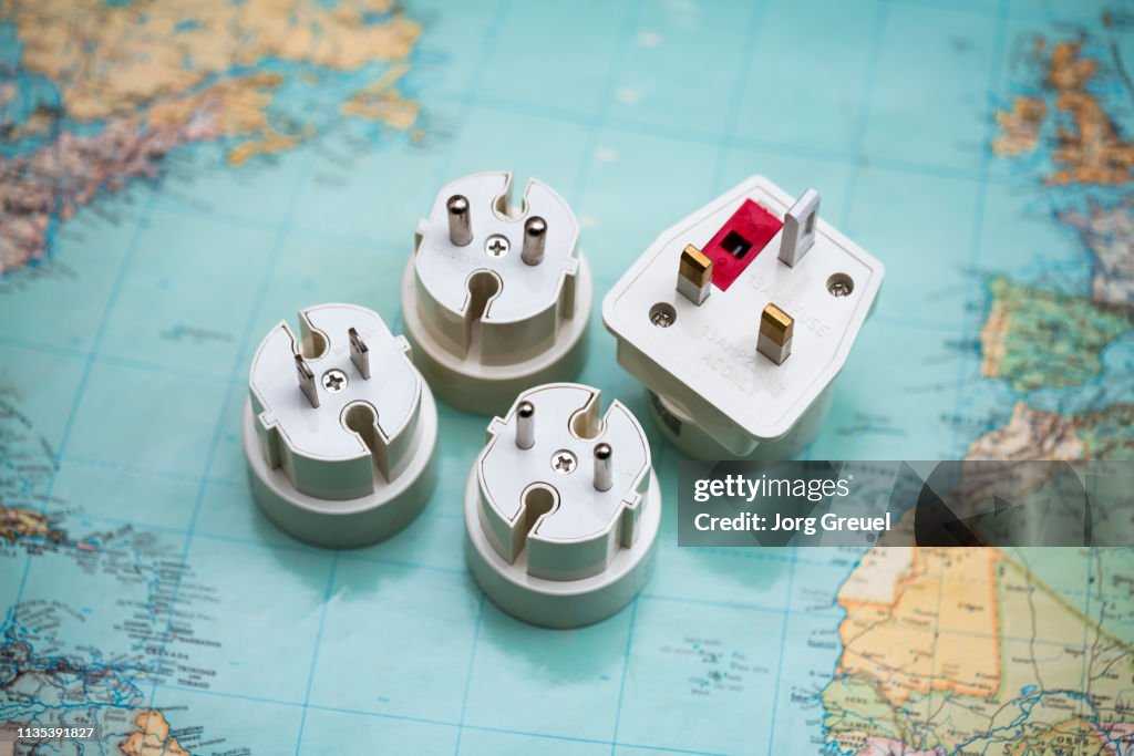 Travel plug adapters on world map