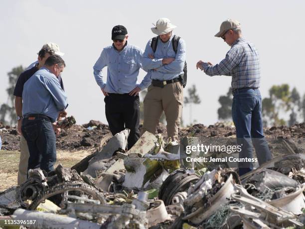 Investigators with the U.S. National Transportation and Safety Board look over debris at the crash site of Ethiopian Airlines Flight ET 302 on March...