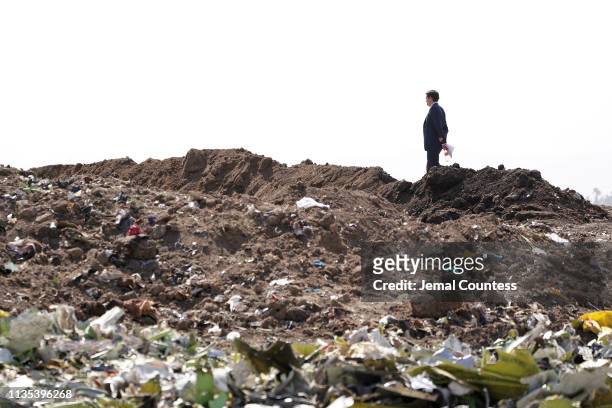 United States Government official inspects the crash site of Ethiopian Airlines Flight ET 302 on March 12, 2019 in Bishoftu, Ethiopia. All 157...