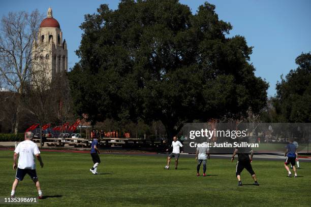 People play soccer near Hoover Tower on the Stanford University campus on March 12, 2019 in Stanford, California. More than 40 people, including...