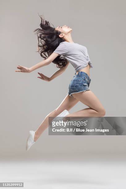 happy young woman dancing - chinese dance stock pictures, royalty-free photos & images