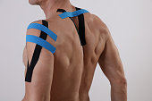 Kinesiology taping. Back pain, Sport man exercising injury. Alternative medicine concept