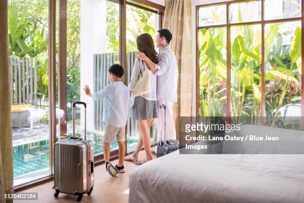 happy young family in hotel room - confort at hotel bedroom ストックフォトと画像