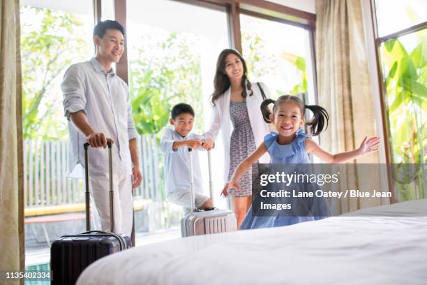 happy young family in hotel room - リゾート　家族 ストックフォトと画像