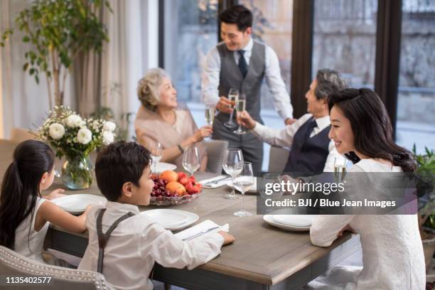 noble family eating holiday meal together - luxury home dining table people lifestyle photography people stock pictures, royalty-free photos & images