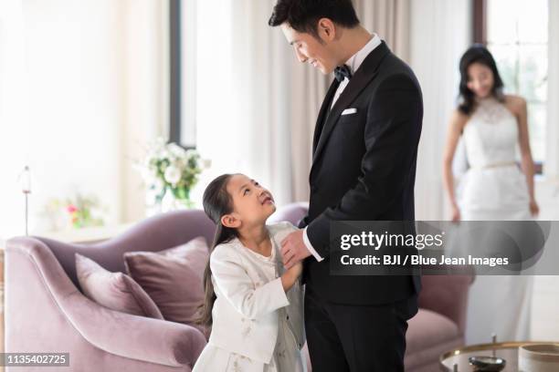 father and daughter holding hands in the livingroom - wealthy family inside home stock pictures, royalty-free photos & images