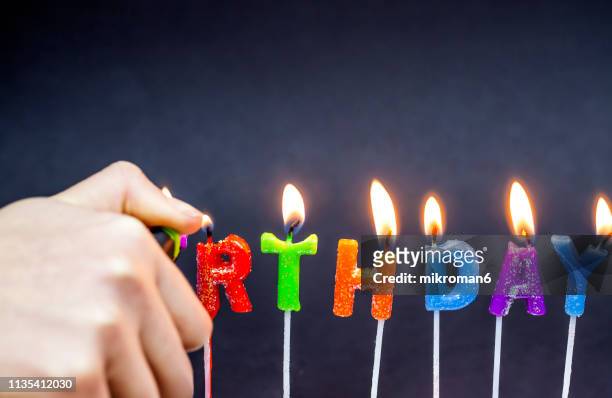 happy birthday candles. candles spelling - birthday candle on black stock pictures, royalty-free photos & images