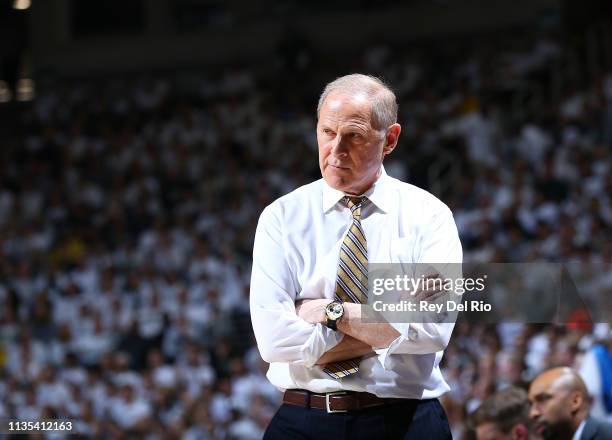 Head coach John Beilein of the Michigan Wolverines looks on from the bench during the first half against the Michigan State Spartans at Breslin...