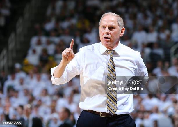 Head coach John Beilein of the Michigan Wolverines looks on from the bench during the first half against the Michigan State Spartans at Breslin...