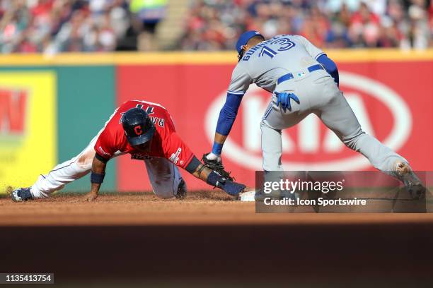 Cleveland Indians third baseman Jose Ramirez holds the base after stealing second as Toronto Blue Jays infielder Lourdes Gurriel Jr. Apples the tag...