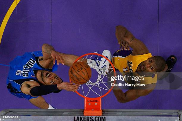 Tyson Chandler of the Dallas Mavericks dunks the ball over his head as Ron Artest of the Los Angeles Lakers looks on in the first quarter of Game One...