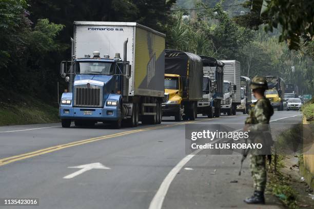 Colombian soldier guards the Pan-American highway after indigenous people agreed to unblock it on April 6, 2019 in Caldono, Colombia. - Colombian...