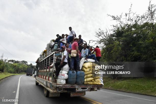 Colombian indigenous people travel on a chiva , on the Pan-American highway following the lifting of the blockade on April 6, 2019 in Santander de...