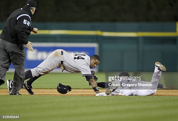 Curtis Granderson of the New York Yankees is tagged out after over sliding the base on a ninth inning steal by Jhonny Peralta of the Detroit Tigers...