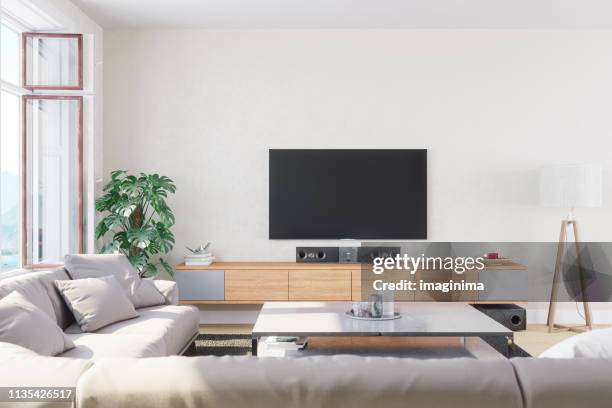 modern, bright and airy living room - living room television stock-fotos und bilder