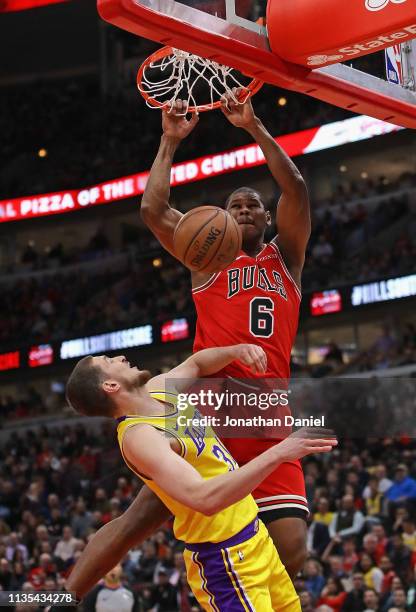 Cristiano Felicio of the Chicago Bulls dunks over Mike Muscala of the Los Angeles Lakers at the United Center on March 12, 2019 in Chicago, Illinois....