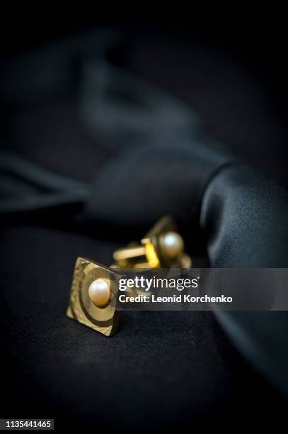 antique cuff links on rich dark background - cufflinks stockfoto's en -beelden