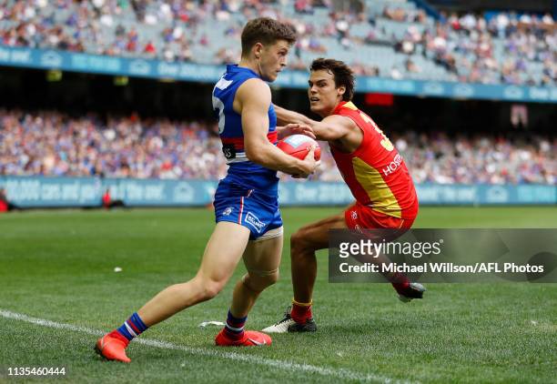 Taylor Duryea of the Bulldogs and Jack Bowes of the Suns in action during the 2019 AFL round 03 match between the Western Bulldogs and the Gold Coast...