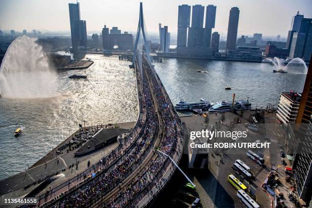 Runners cross the Erasmus bridge as they compete during the 39th Rotterdam Marathon in Rotterdam, on April 7, 2019. / Netherlands OUT