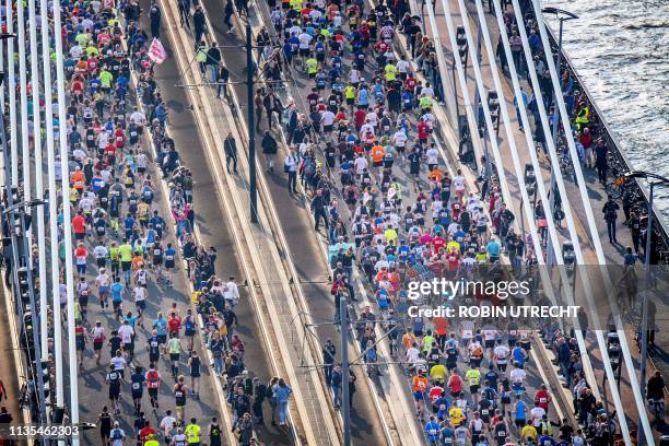 Runners cross the Erasmus bridge as they compete during the 39th Rotterdam Marathon in Rotterdam, on April 7, 2019. / Netherlands OUT