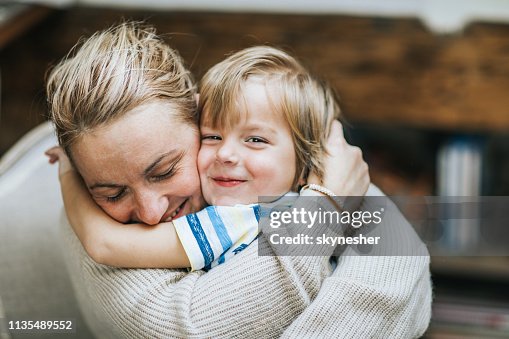 Affectionate mother and son embracing at home. Affectionate mother and son embracing at home.
