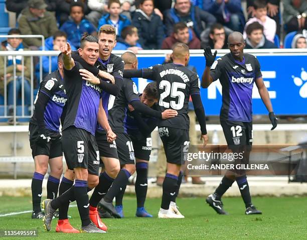 Leganes' Argentinian defender Jonathan Silva celebrates with teammtes after scoring during the Spanish league football match between Deportivo Alaves...