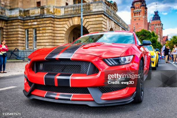 red ford gt shelby parked on a street - ford mustangs stock pictures, royalty-free photos & images