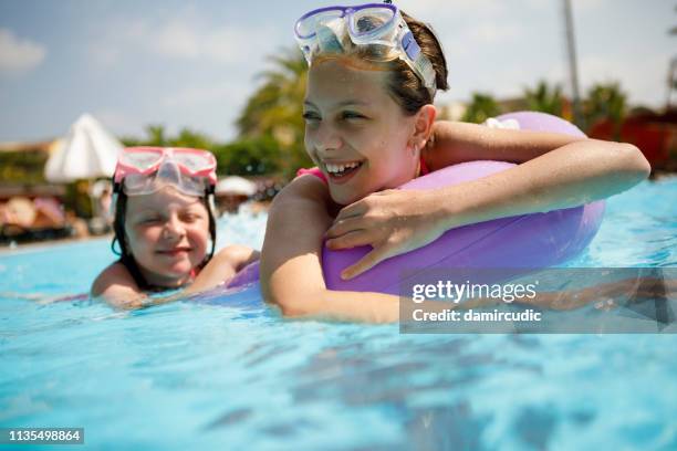 kids having fun in swimming pool - lido stock pictures, royalty-free photos & images