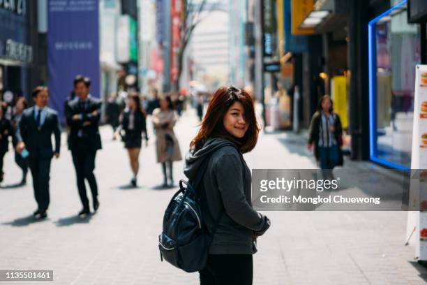young asian woman traveler traveling and shopping in myeongdong street market - native korean stock-fotos und bilder