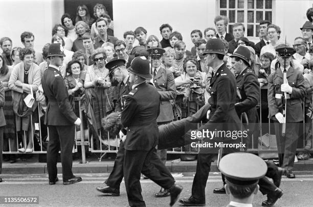 The Investiture of Prince Charles at Caernarfon Castle, Pictured, policemen carry away a man, Caernarfon, Wales, 1st July 1969.