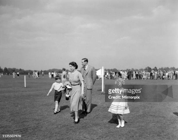 Queen Elizabeth II with Prince Charles and Princess Anne at Windsor Great Park to watch the Duke of Edinburgh playing polo, 13th May 1956.