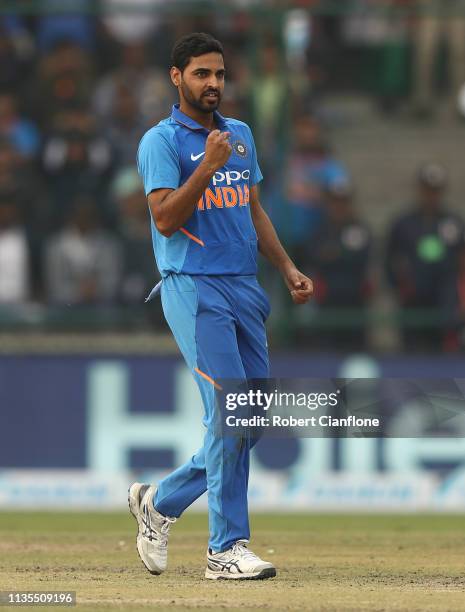 Bhuvneshwar Kumar of India celebrates taking the wicket of Marcus Stoinis of Australia during game five of the One Day International series between...