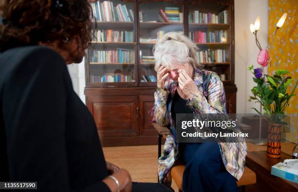 senior woman visiting a senior counselor - old lady crying out for help stock pictures, royalty-free photos & images