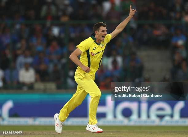 Pat Cummins of Australia celebrates taking the wicket of Shikhar Dhawan of India during game five of the One Day International series between India...
