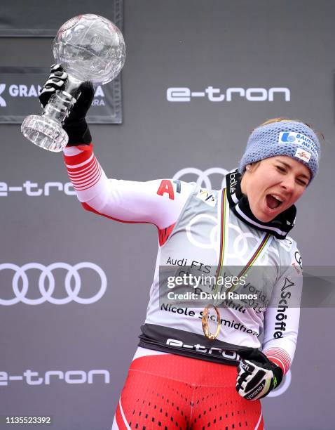 Nicole Schmidhofer of Austria celebrates winning the Audi FIS Alpine Ski World Cup with the trophy after during the Women's Downhill on March 13,...