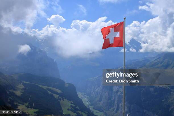 swiss flag flying over lauterbrunnen switzerland - swiss flag fotografías e imágenes de stock