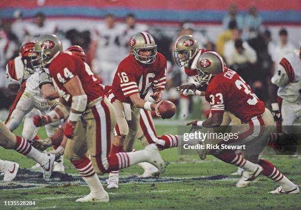 Joe Montana, Quarterback for the San Francisco 49ers hands the ball off to running back Roger Craig during the National Football League Super Bowl...