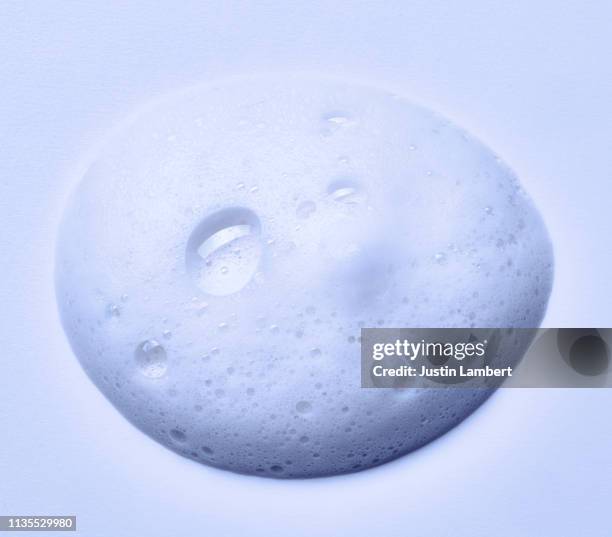 soap suds dropped on to white backdrop - frothy drink stock pictures, royalty-free photos & images