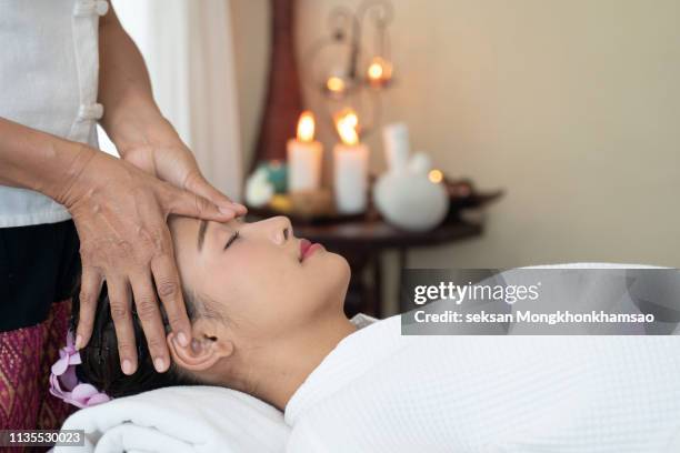 asian young woman enjoying scalp massage - thai massage stock pictures, royalty-free photos & images