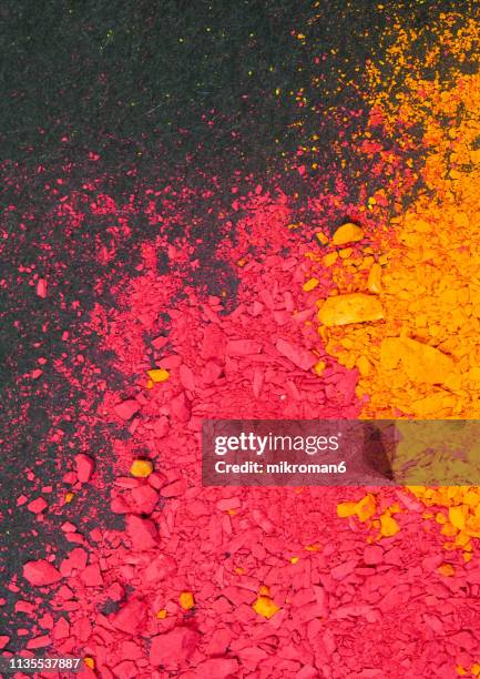 multicolored piles of pigment powder of orange and red color - orange powder ストックフォトと画像