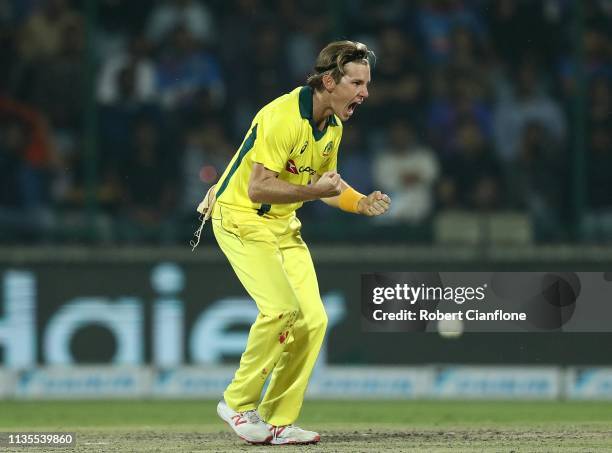 Adam Zampa of Australia celebrates taking the wicket of Rohit Sharma of India during game five of the One Day International series between India and...