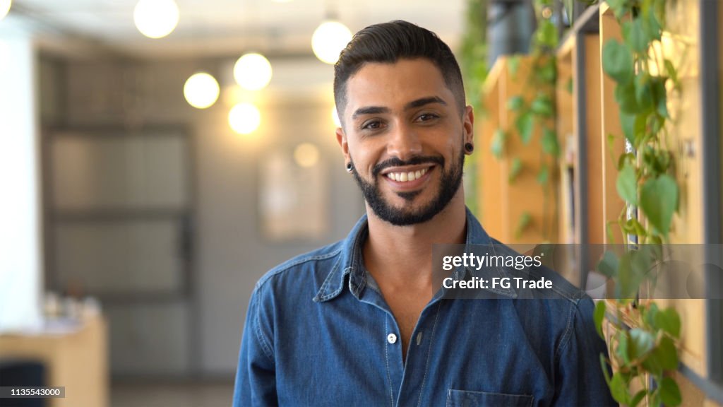 Latin businessman portrait standing at work studio