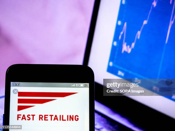 In this photo illustration a Fast Retailing Co, Ltd logo seen displayed on a smart phone.