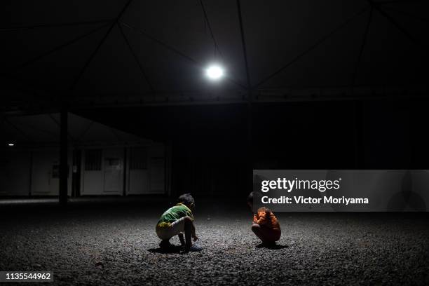 Two boys play at night as theenergy supply of the city of Pacaraima is made by Venezuela and therefore blackouts are frequent April 6, 2019 in...