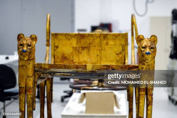 This picture taken on April 7, 2019 shows a view of one of the artefacts of the Tutankhamun collection currently undergoing work at the restoration...