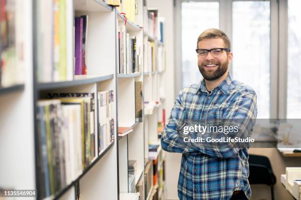 smiling male student - librarian stock pictures, royalty-free photos & images